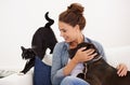 The love rubs off on everybody in her house. Shot of a beautiful young woman relaxing on the couch with her dog and cat. Royalty Free Stock Photo