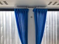 Shot of blue curtains installed on the windows of new air conditioned bus in second layer of white curtains background Royalty Free Stock Photo