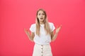 Shot of bored annoyed beautiful teenage girl with straight blond hair looking at camera with boring and annoying face Royalty Free Stock Photo