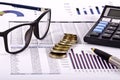 Financial tools, calculator, pen and specs over a report Royalty Free Stock Photo