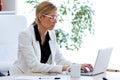 Business young woman working with her laptop in the office. Royalty Free Stock Photo