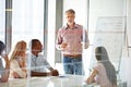 Sharing his experience and teaching them about business. Shot of a businessman presenting his ideas to his colleagues Royalty Free Stock Photo