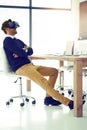 The future never looked better. Shot of a businessman wearing a VR headset while leaning back in his office chair at Royalty Free Stock Photo