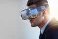 Envisioning his empire. Shot of a businessman wearing a VR headset while working in his office. Royalty Free Stock Photo