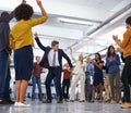 Office entertainment. Shot of a businessmen dancing in the centre of a circle of coworkers.