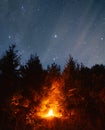 Camp fire in the forest with long exposure night sky. Alone in the forest at night Royalty Free Stock Photo