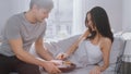 Shot of a Caring Young Man Bringing Tray with Breakfast in Bed to His Lovely Female Partner. Ideal Royalty Free Stock Photo
