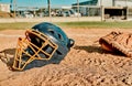 Baseball is for everyone. Shot of a catchers helmet lying on a baseball field. Royalty Free Stock Photo