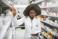 This is in the right place. Shot of a cheerful young female pharmacist checking stock on the shelves of a pharmacy. Royalty Free Stock Photo