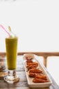 Everything goes well with wings. Shot of chicken wings and a shake sitting on a table in an oceanside restaurant in Royalty Free Stock Photo