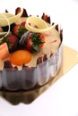 Shot chocolate cake topped with fresh fruit.