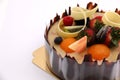 Shot chocolate cake topped with fresh fruit.