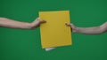 In the shot close up on a green background, chromakey. The woman holds in her hand a yellow folder with documents. She Royalty Free Stock Photo