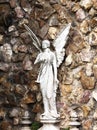 Angel with the trumpet by the wall Royalty Free Stock Photo