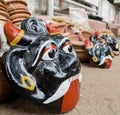 A shot of a colored mask made of clay. These type of face painted plates are held in front of new construction as a part of ritual