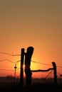 Colorful country Kansas Sunset with a fenceline silhouette out in the country. Royalty Free Stock Photo