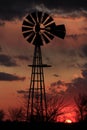 Kansas Windmill sillhouette with storm clouds out in the country.