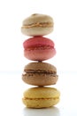 Shot of colorful yummy French macaroons stacked on the white background