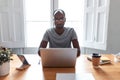 Concentrated young black business man working with laptop in the office