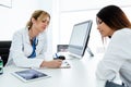 Confident female doctor prescribing medication for patient in the medical consultation Royalty Free Stock Photo