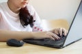 Shot of confident young Asian woman worker sit at office table by laptop search data browse corporate network Royalty Free Stock Photo