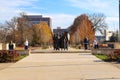 A shot of the copper statues at the Tennessee Woman`s Suffrage Monument surrounded by gorgeous autumn colored trees