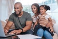Its never to early to start investing for her future. Shot of a couple and their little daughter using a laptop at home. Royalty Free Stock Photo