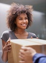 Delivering direct to your door. Shot of a courier making a delivery to a smiling customer.