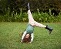 Doing cartwheels is so much fun. Shot of a cute little girl doing cartwheels on the grass. Royalty Free Stock Photo