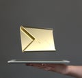 Shot of a 3d rendered golden envelope floating on top of a smart device - concept of social chat