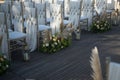 Shot of decorated white chairs for a wedding reception in the evening Royalty Free Stock Photo