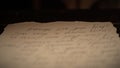 Shot of the desk with aged paper sheets. Close up of historical love letter calligraphy handwritten text on old Royalty Free Stock Photo