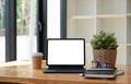 Shot of digital tablet with blank white screen, keyboard, cup of coffee on workspace desk Royalty Free Stock Photo