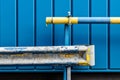 Shot of dirty rusty tubes in front of a beautiful modern blue wall Royalty Free Stock Photo