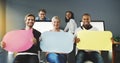 Weve got a message from the team. Shot of a diverse group of people holding up speech bubbles in a modern office. Royalty Free Stock Photo