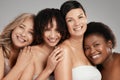 You grow where you feel accepted. Shot of a diverse group of women standing and hugging each other in the studio. Royalty Free Stock Photo