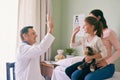 High-five for a brave little girl. Shot of a doctor giving his young patient a high five after her checkup. Royalty Free Stock Photo