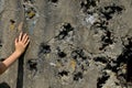 Shot down concrete fortification with a machine gun. bullet holes pointed by the hand of a little boy. marveles at the terrible ef Royalty Free Stock Photo