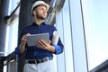 Shot of a engineer using a digital tablet on a construction site. This software help me to keep track of everything