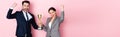 Shot of excited businessman and businesswoman holding trophy and gesturing on pink, gender equality concept