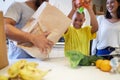 Helping the family to make supper. Shot of a family unpacking the groceries in the kitchen at home. Royalty Free Stock Photo