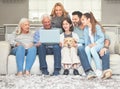 Never a dull moment when were together. Shot of a family using a laptop while sitting on a sofa together at home. Royalty Free Stock Photo