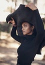 A womans hat should speak volumes. Shot of a fashionable young woman posing against a nature background.