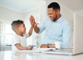 Thats my boy. Shot of a father and son doing homework together at home. Royalty Free Stock Photo