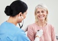 Living life with a positive attitude and a healthy heart. Shot of a female doctor examining a patient with a stethoscope Royalty Free Stock Photo