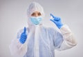 The vaccine has been approved. Shot of a female nurse holding a vaccination vial against a studio background. Royalty Free Stock Photo