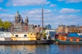 Shot of fishing vessels on the background of the Basilica of Saint Nicholas in Amsterdam Royalty Free Stock Photo