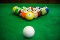 Shot of foot pool balls standing on green table.