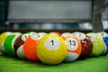 Shot of foot pool balls standing on green table.