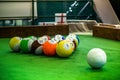 Shot of foot pool balls standing on green table.